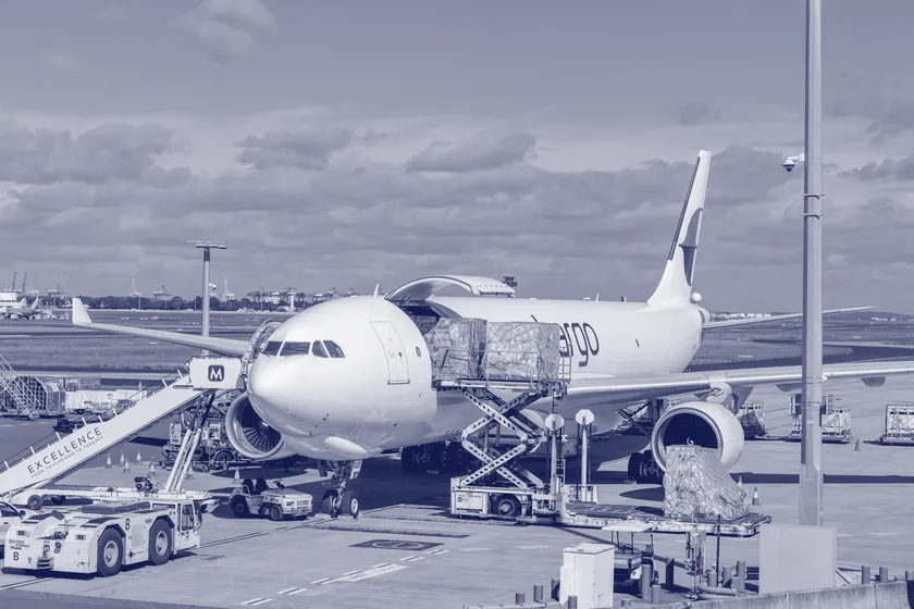A freighter aircraft being loaded on the apron
