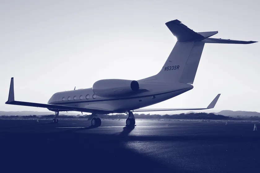 A business jet on the tarmac at dusk